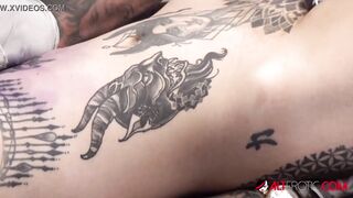 Sascha plays with Amber Luke while she gets tattooed